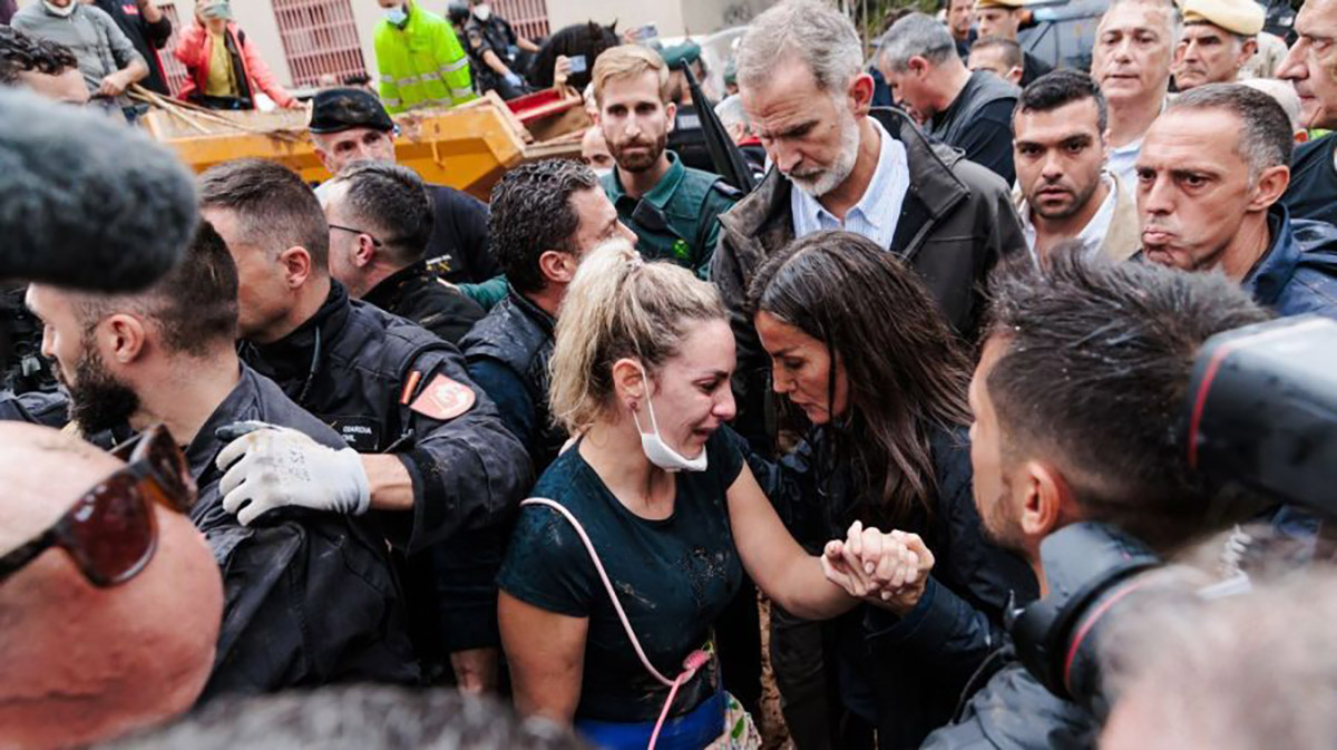 Los reyes de España caminan por las calles de Valencia, abucheados por la mayoría de la población quienes les arrojaron barro y objetos mientras pasaban.